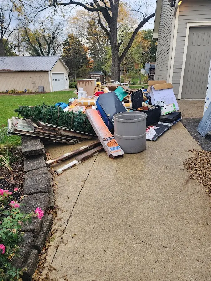 Dumpster being loaded with debris for Estate Cleanout Dumpster Rental in Circle Pines